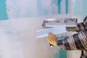 Work hand tool wall using plastering tool for unfinishing wall